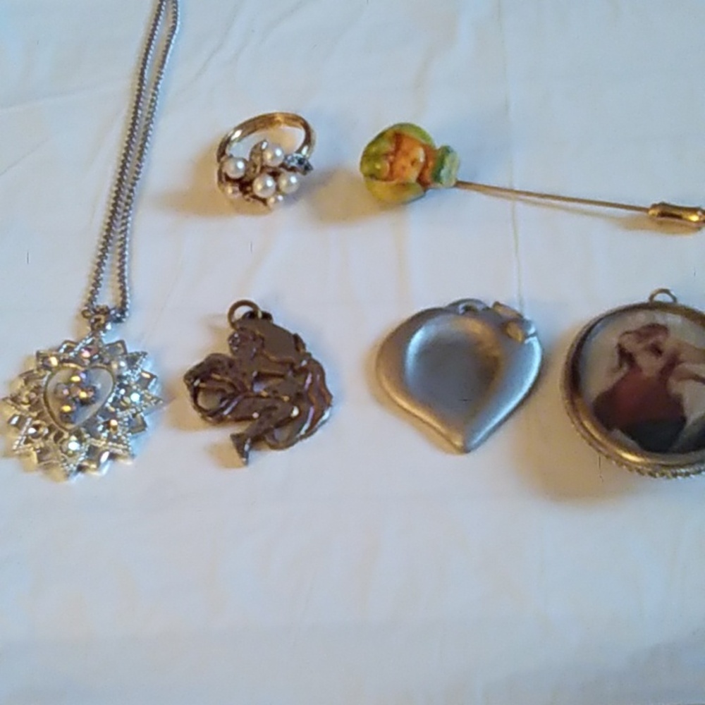 A combination of items (necklace,ring, pendant and broach pin)